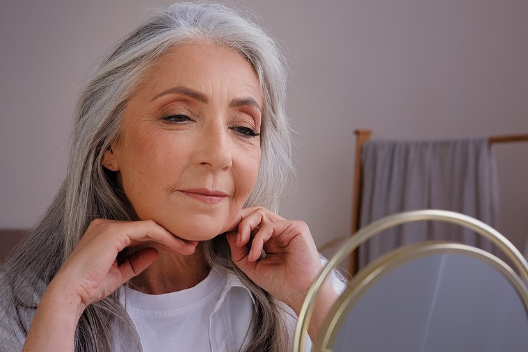 Senior Mature Lady looking in mirror anti-aging ageism