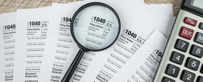 blank of individual tax form with magnifying glasses tax deduction tax deductions