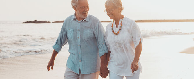 Couple dancing together and having fun on the sand at the beach retirement in Florida retirement