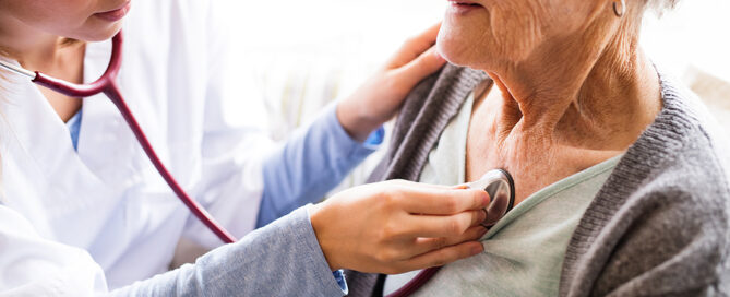 A nurse or a doctor examining a woman. ccrc health evaluation