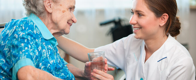 Senior woman with her caregiver at home; respite care family caregivers adult day care