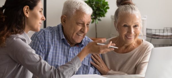 older couple meeting with sales counselor; senior living decisions senior living prospects