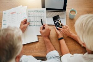 senior living affordability; older adult couple calculating budget