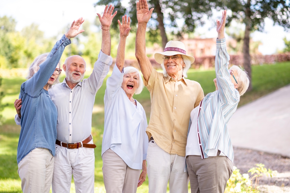 group of happy older adults in a park; I wish I’d moved sooner