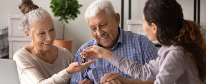 Retired Couple talking with a senior living representative; senior living decision fears