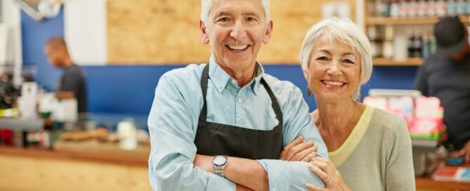 older adult couple in a store; working after retirement