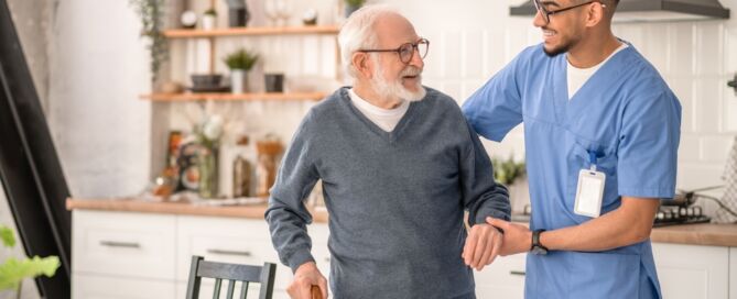 Medical Worker Helping older man in his home; home- and community-based services