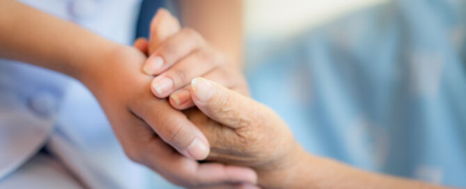 Sitting,On,A,Hospital,Bed,Next,To,An,Older patient; death doula