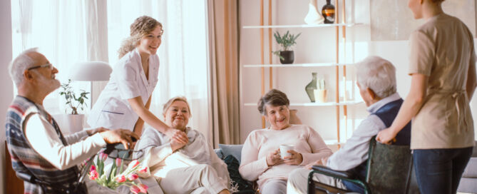 Group of older adults living in a Green House Project model home with caregivers