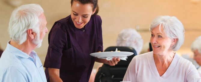 Senior,Couple,Being,Served,With,Meal,,In,Dining room; senior living hospitality