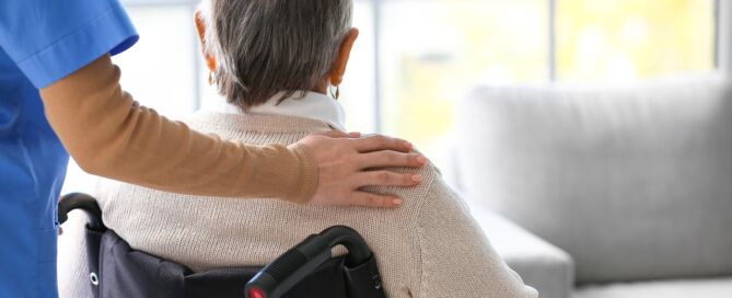 Senior,Woman,In,Wheelchair,With,Caregiver transfer trauma